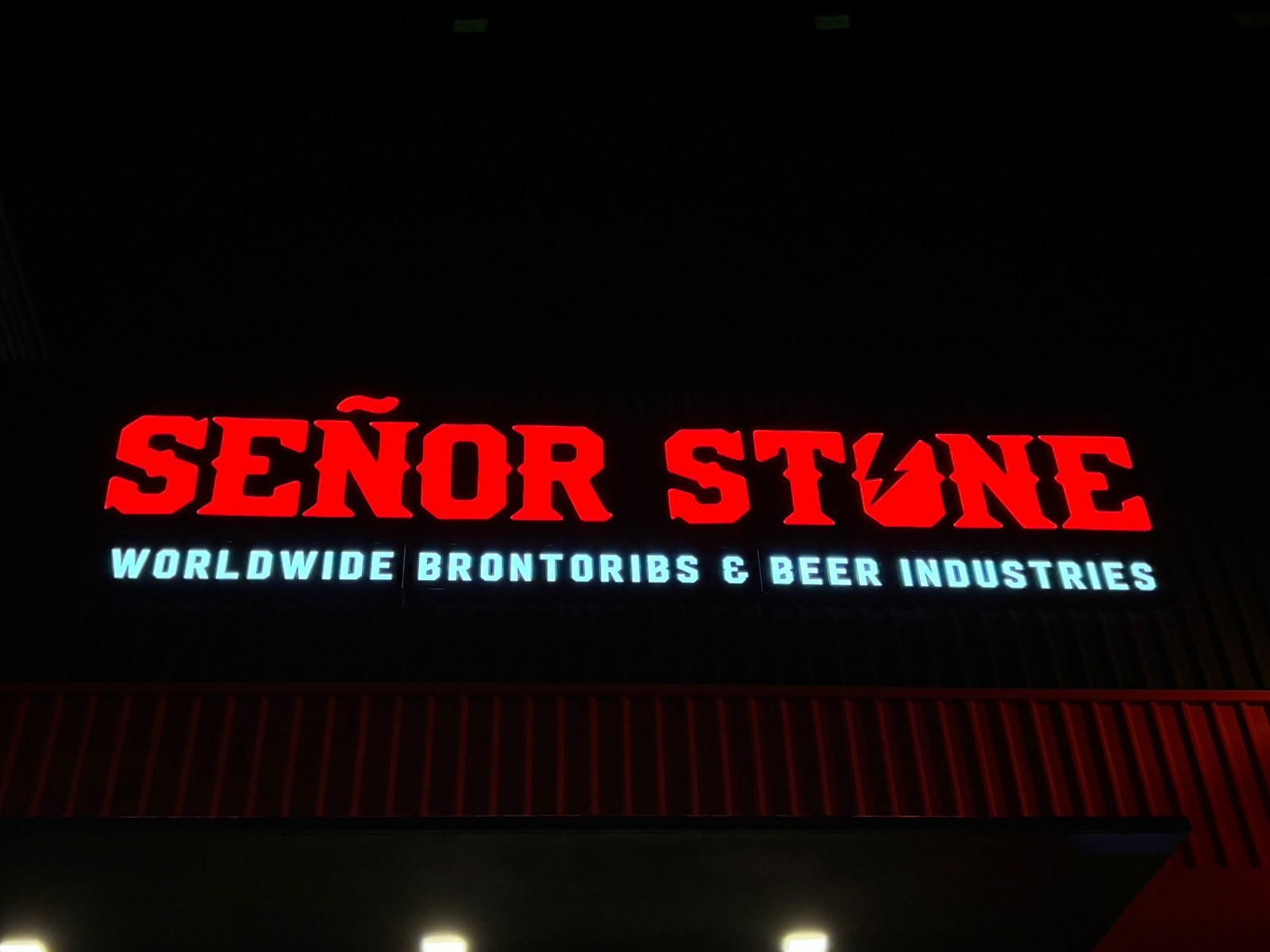 Fachada de restaurante con letras de bloque rojas iluminadas